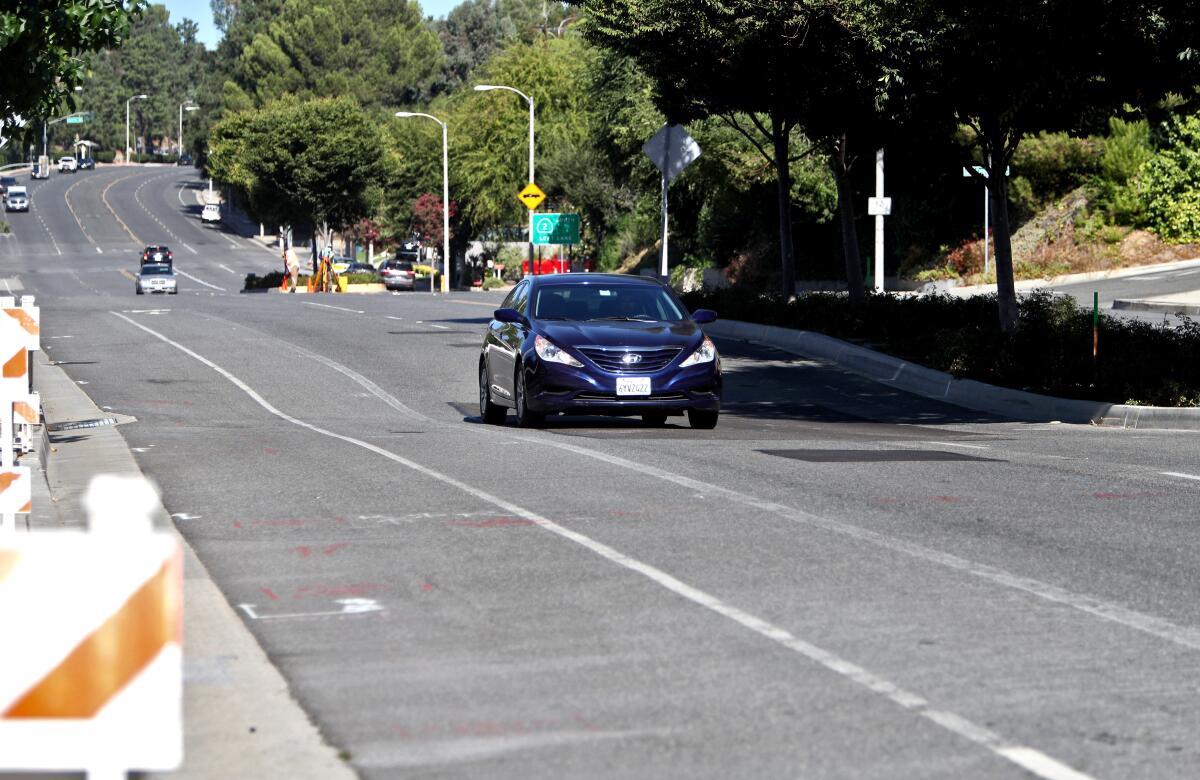 A vehicle passes a dip on the 1700 block of Foothill Boulevard in La Cañada. On Tuesday, the La Cañada Flintridge City Council approved up to $100,000 in emergency repairs to safeguard the roadway before seasonal rain degrades conditions there.