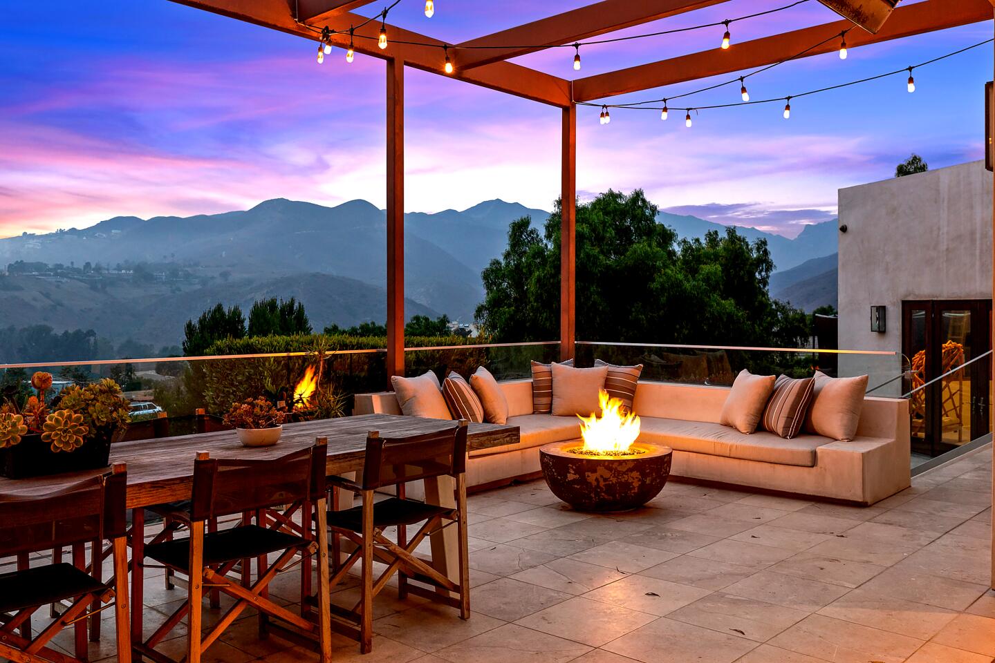 A view of the hills and landscaping from a furnished patio area.
