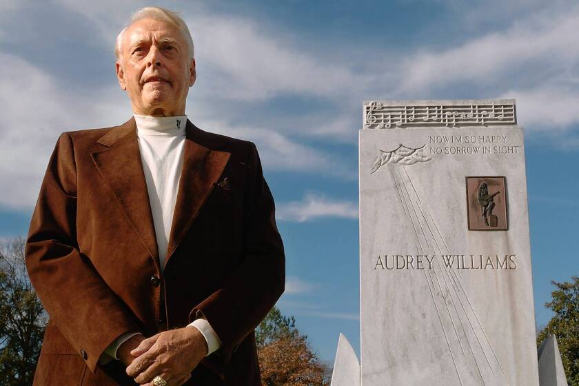 Charles Carr in 2007 at the graves of Hank and Audrey Williams in Oakwood Cemetery in Montgomery, Ala.