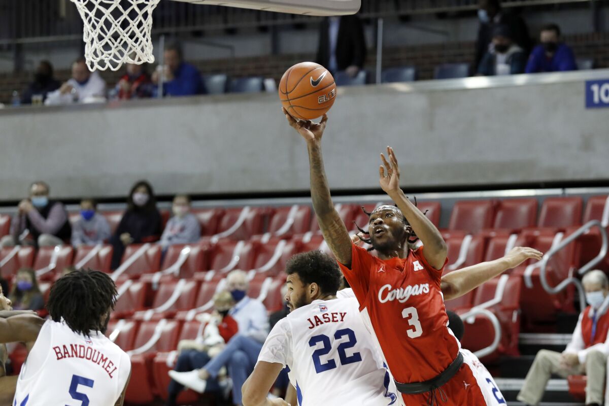Houston guard DeJon Jarreau (3) takes a shot while SMU forward Isiah Jasey (22) defends during the first half of an NCAA college basketball game in Dallas, Sunday, Jan. 3, 2021. (AP Photo/Roger Steinman)