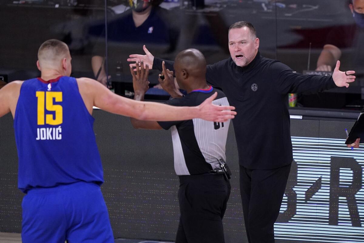 Nuggets center Nikola Jokic  and head coach Michael Malone reacts to a call by referee Courtney Kirkland.