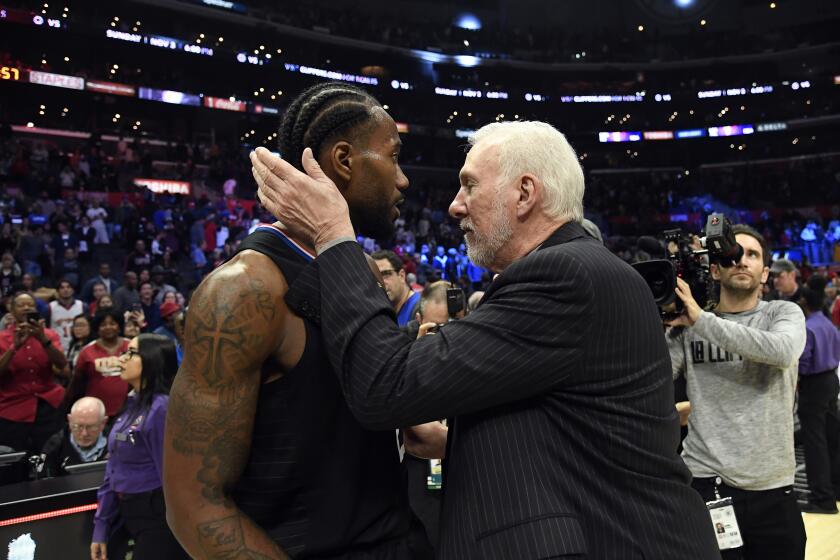 Clippers forward Kawhi Leonard gets a hug from his former head coach, Gregg Popovich, after scoring game-high 38 points against the Spurs on Oct. 31, 2019, at Staples Center.