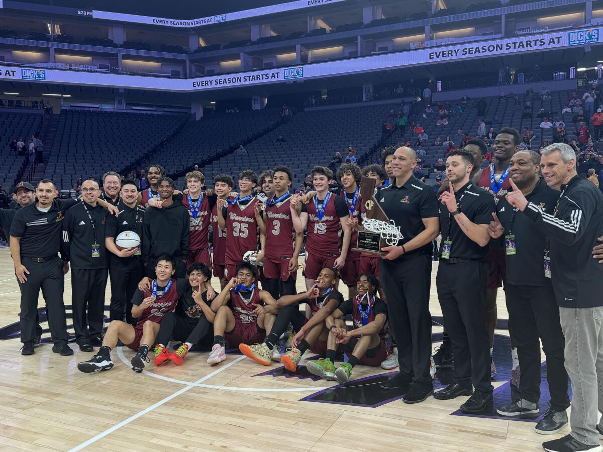 Bishop Alemany's players and coaches pose for a photo after winning the Division III state boys' basketball title.