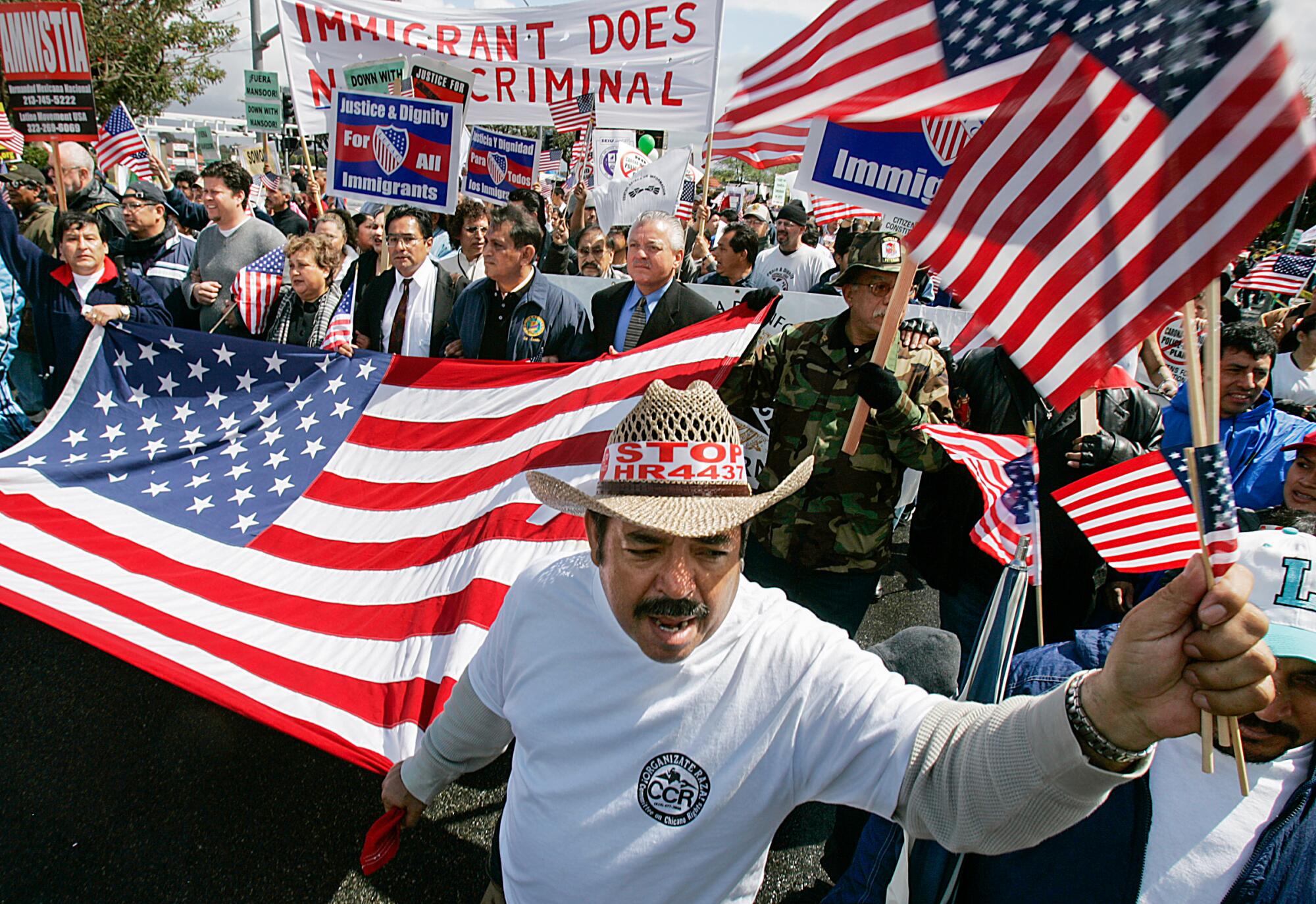 Demonstrators march down Fair Drive Saturday, April 1, 2006, during a protest and rally at Costa Mesa City Hall.