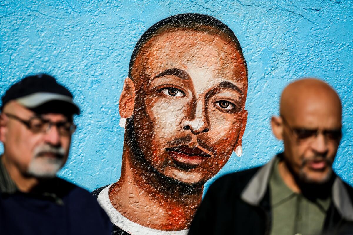 At the corner of 65th Street and Broadway in South Los Angeles, the site of the LAPD's fatal shooting of Ezell Ford is memorialized on a wall. (Jay L. Clendenin / Los Angeles Times)