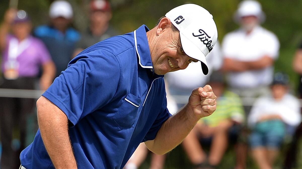 Greg Chalmers sinks a birdie putt to take the lead on the final hole of the Australian PGA championship on Sunday.