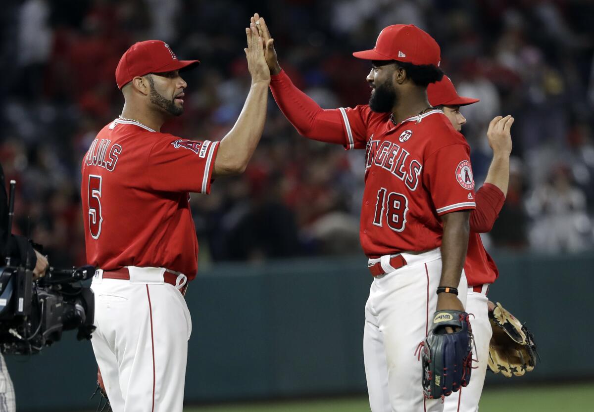  Angels' Albert Pujols, left, and Brian Goodwin celebrate after a 7-2 win over the Houston Astros.