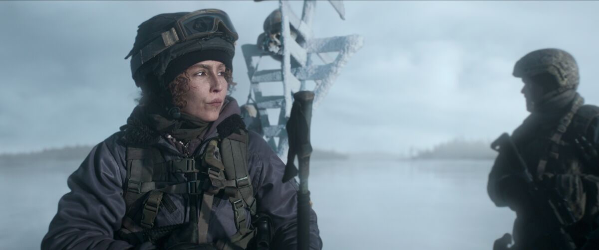 A woman wearing military snow gear in the movie "Black Crab."