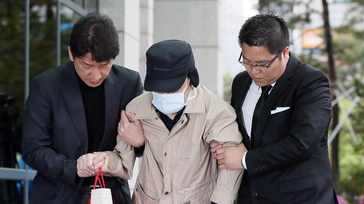 Kim Han-sik, center, president of the Cheonghaejin Marine Co., the operator of the sunken Sewol ferry, enters the Incheon District Prosecutors' Office in Incheon, South Korea, on April 29.