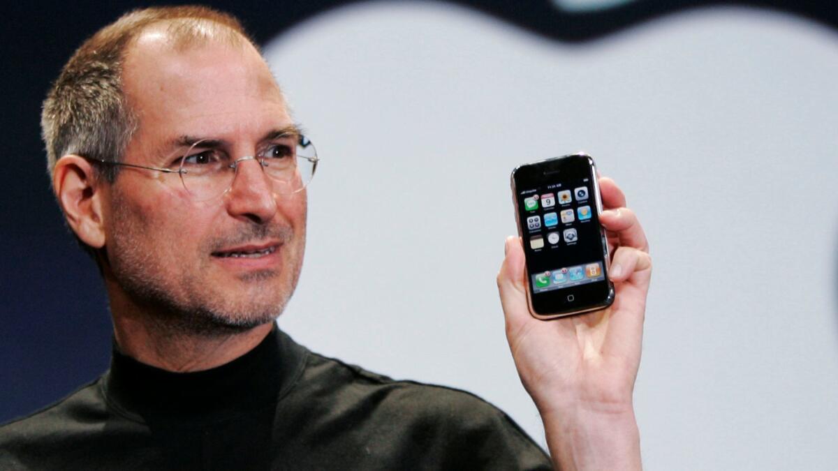 Steve Jobs, Apple's founder and late Chief Executive, holds up an iPhone at the 2007 MacWorld Conference in San Francisco.