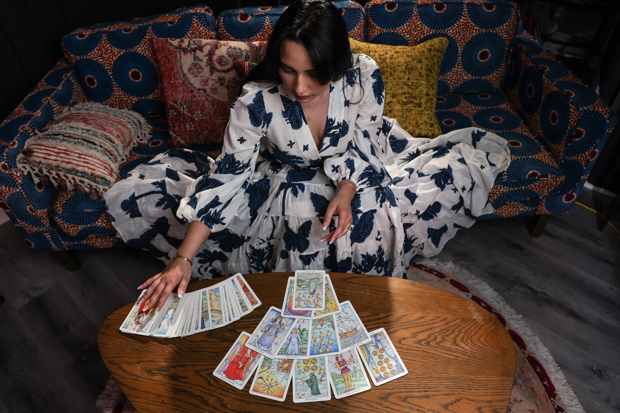 Paulina Stevens lays out tarot cards on a table.