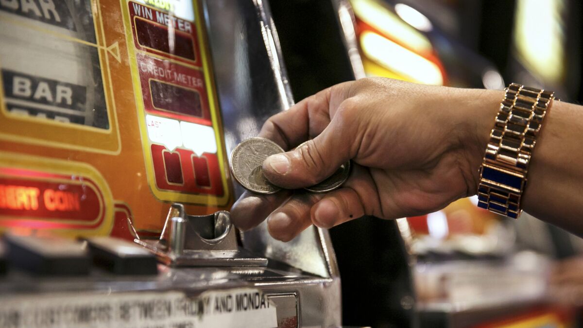 Emilio Rivera, from Barstow, inserts coins into a slot machine at Circus Circus Hotel & Casino in Las Vegas.
