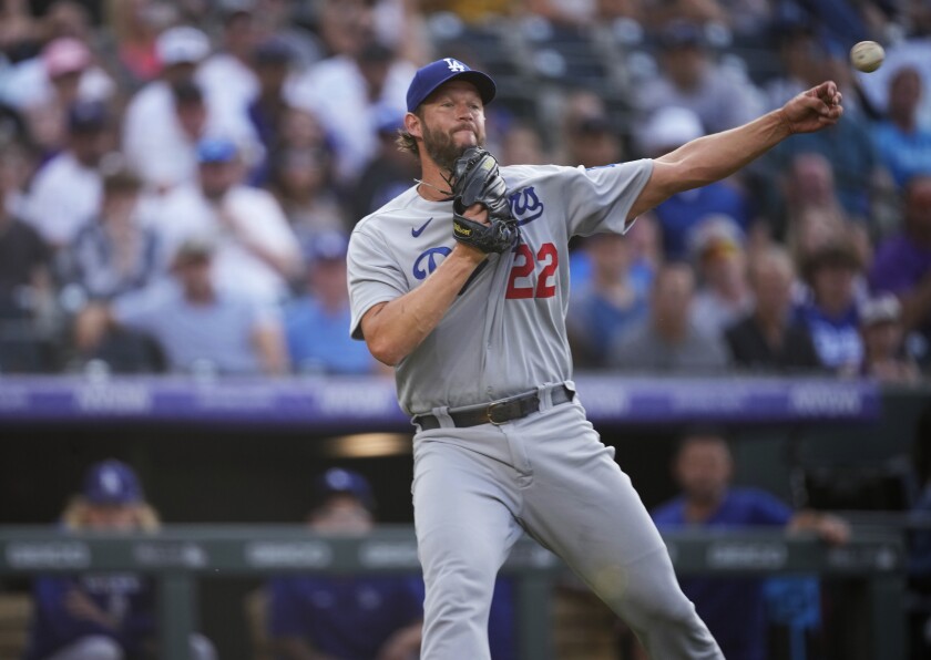 Dodgers pitcher Clayton Kershaw throws to first base.