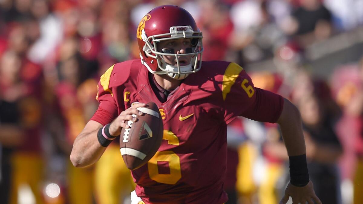 USC quarterback Cody Kessler runs out of the pocket while looking to pass during a 49-14 win over Notre Dame at the Coliseum on Nov. 29, 2014.