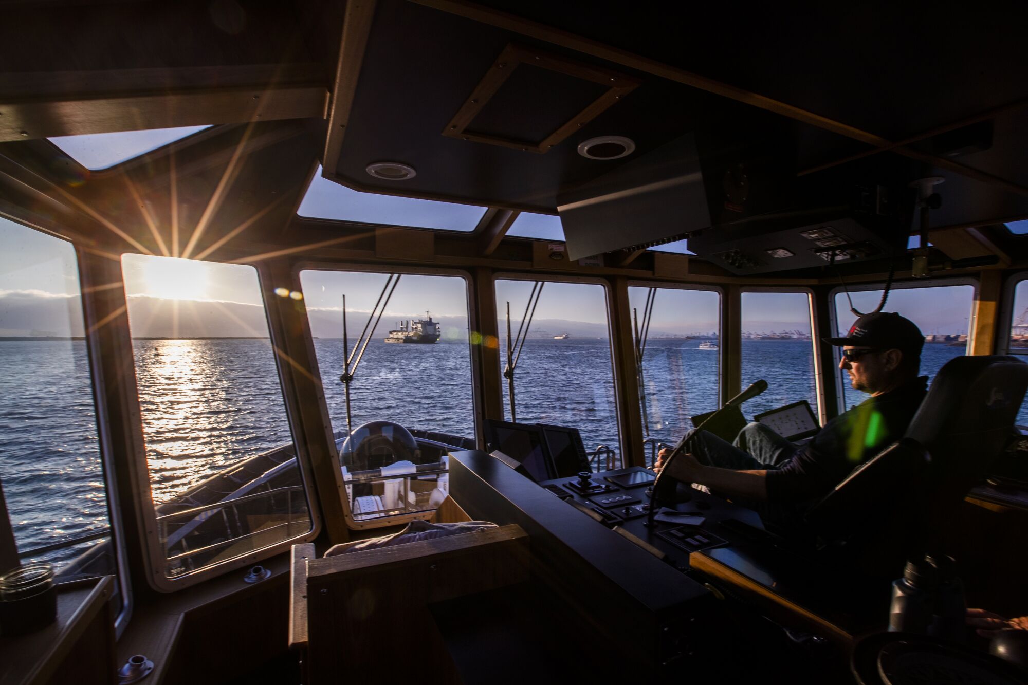 Capt. Mike Johnson scans the horizon from the wheelhouse of the tugboat Delta Teresa.