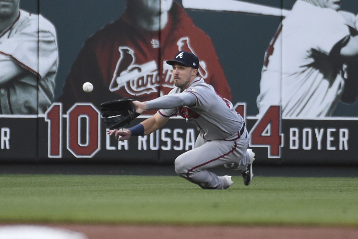 Atlanta Braves left fielder Adam Duvall catches a fly ball hit by St. Louis Cardinals' Yadier Molina during the first inning of a baseball game Wednesday, Aug. 4, 2021, in St. Louis. (AP Photo/Joe Puetz)