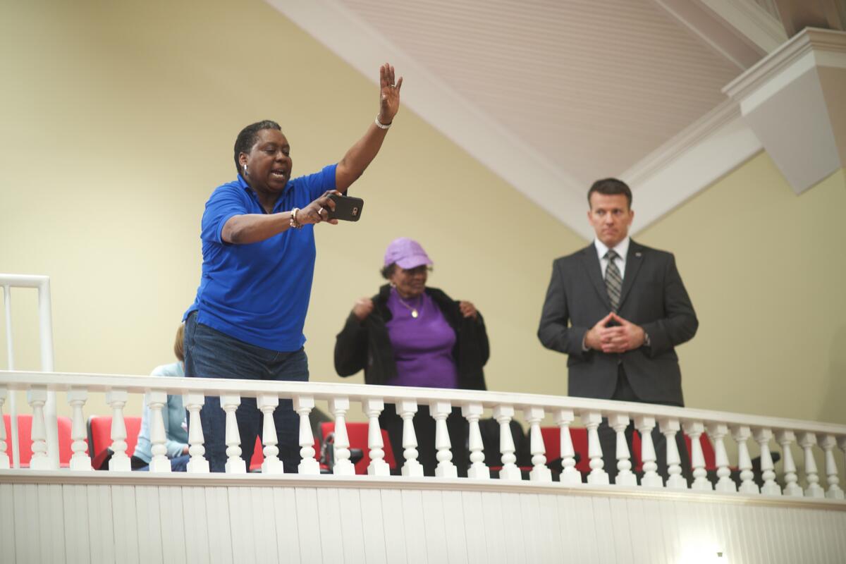 A supporter waves to Hillary Clinton at a town hall meeting with Sen. Cory Booker (D-N.J.) at the Cumberland United Methodist in Florence, S.C. on Feb. 25, 2016