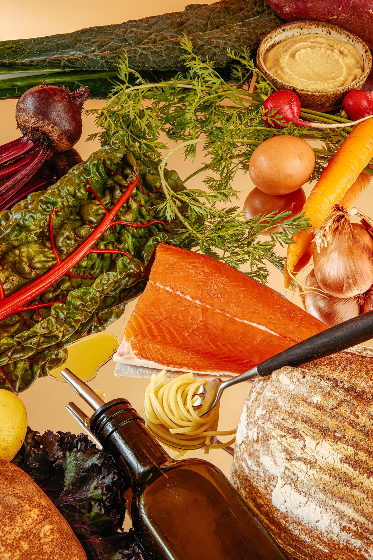Staples of the Mediterranean diet: grains, root vegetables, olive oil, hummus, leafy greens and lean fish like salmon.