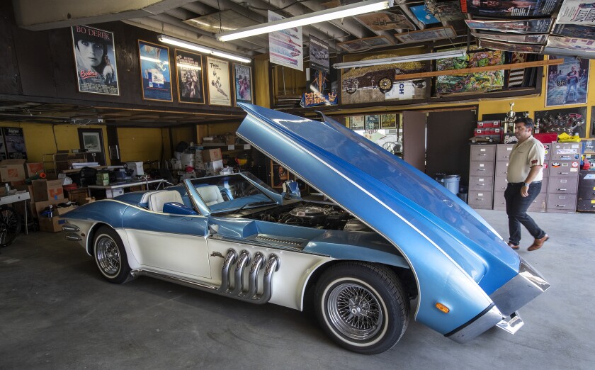 Jared Barris walks next to the Barrister, a custom coach built by the late George Barris on a 1973 Corvette chassis.