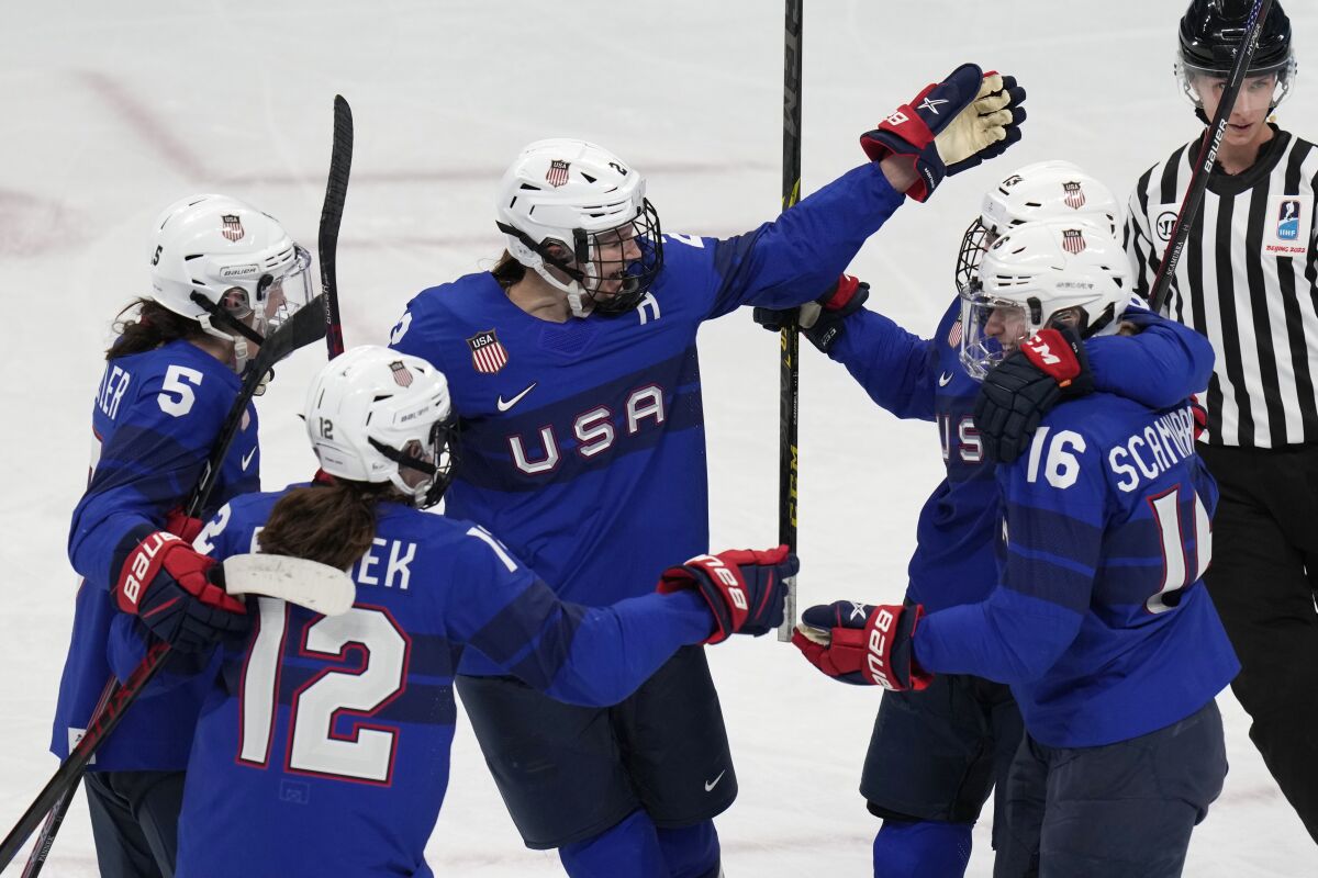 United States' Lee Stecklein (2) celebrates a goal with teammates during a women's quarterfinal hockey game against the Czech Republic at the 2022 Winter Olympics, Friday, Feb. 11, 2022, in Beijing. (AP Photo/Petr David Josek)