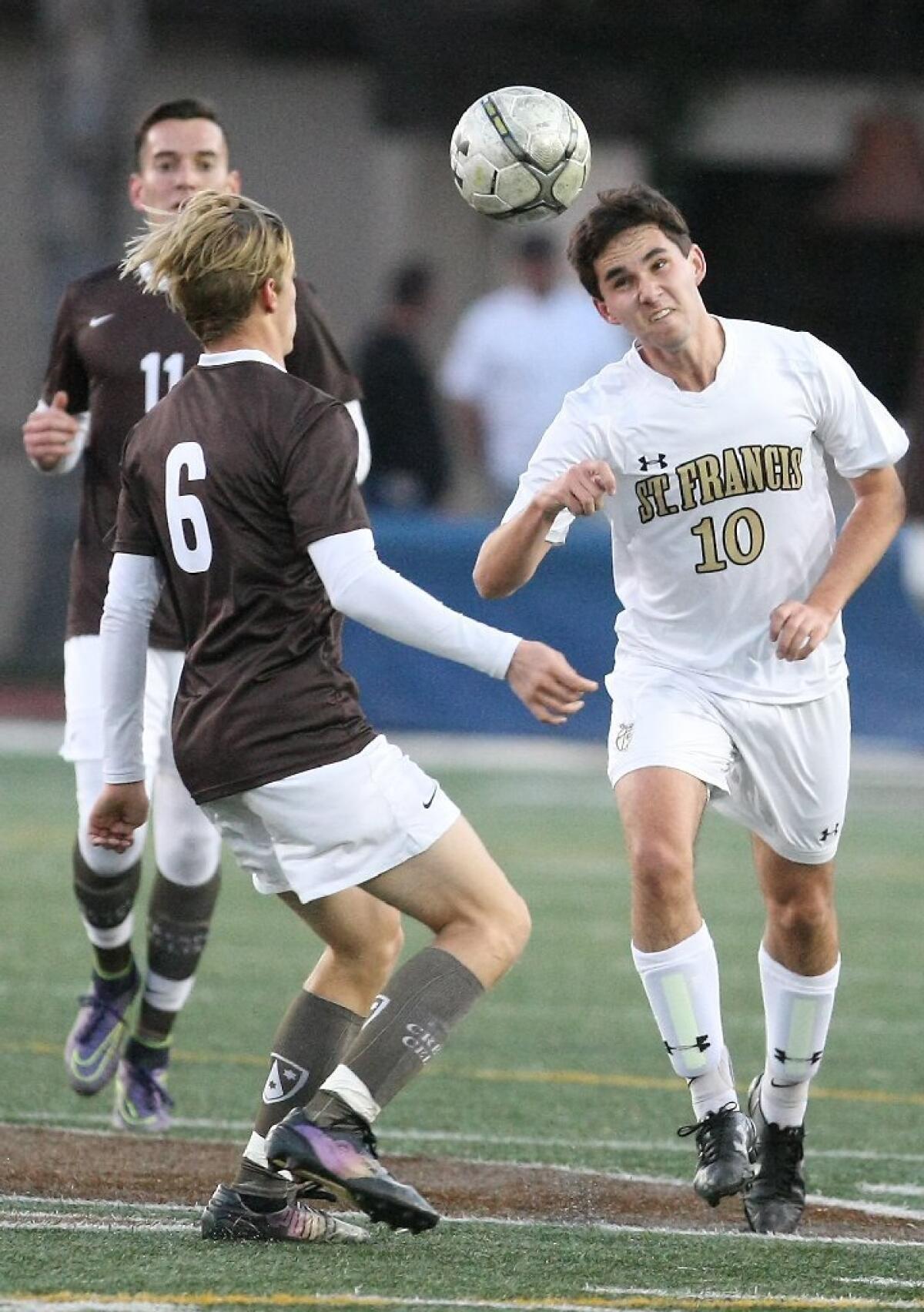 St. Francis' Clayton Green heads the ball away from Crespi's Andrew Angarano