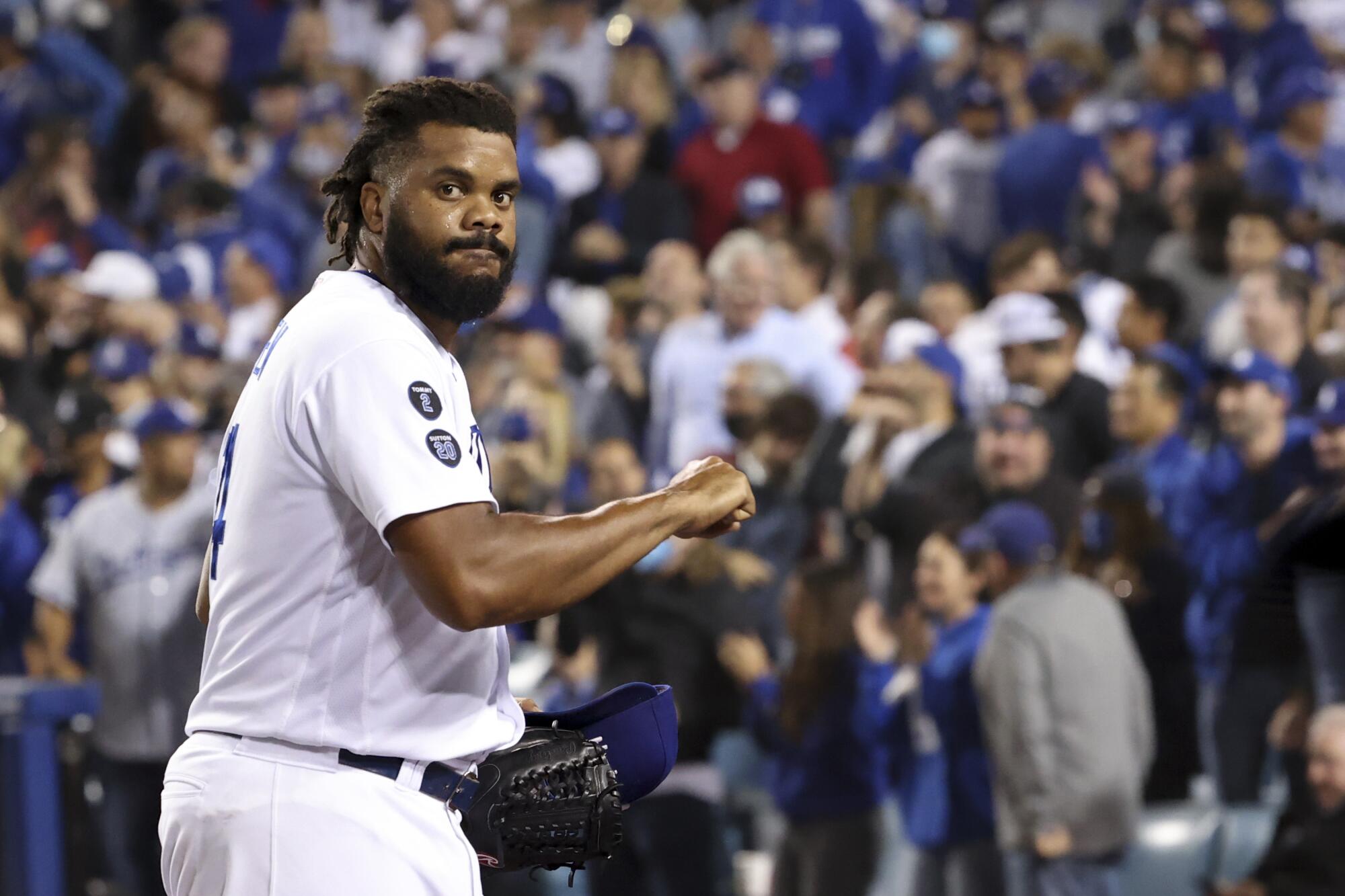 Los Angeles Dodgers relief pitcher Kenley Jansen walks off the field after retiring the side