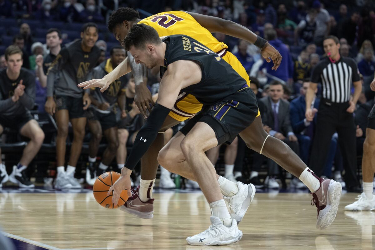 Minnesota forward Pharrel Payne, back, and Northwestern forward Robbie Beran struggle for control of the ball during the first half of an NCAA college basketball game Saturday, Jan. 28, 2023, in Evanston, Ill. (AP Photo/Erin Hooley)
