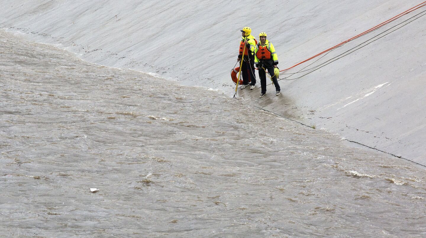 Los Angeles Fire Department swift water rescue personnel deploy along the LA River after a report of a child in the water in Winnetka, Calif.