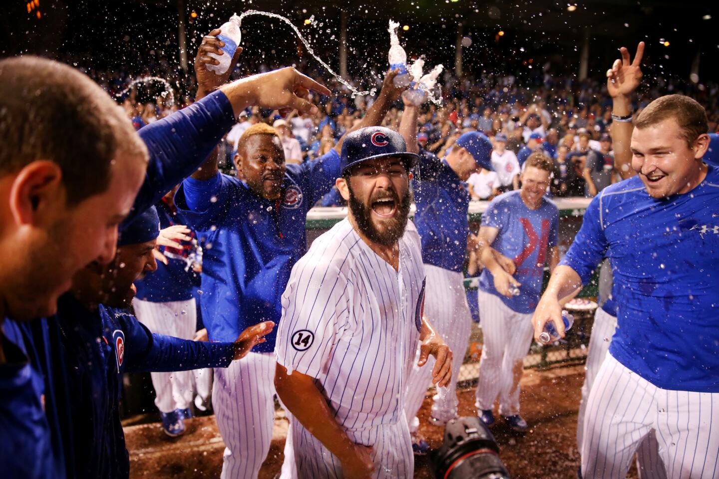 Jake Arrieta is doused by his teammates after recording his 20th win of the season.