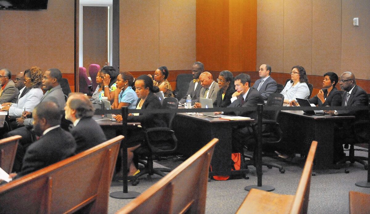 Defendants in a school cheating case and their attorneys listen during a hearing in Fulton County Superior Court this month. Twelve former Atlanta Public Schools employees are accused of boosting students' scores by altering answers in standardized tests.