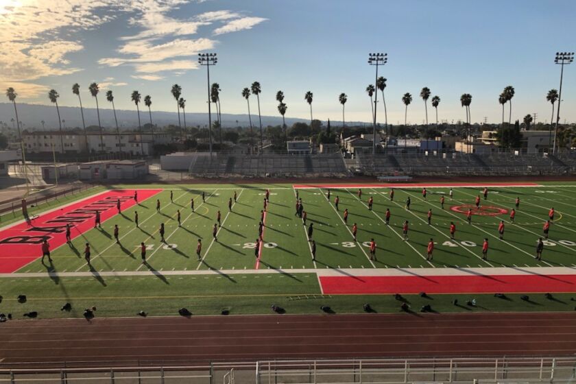 Banning football players working out last month when LAUSD allowed teams to engage in conditioning.