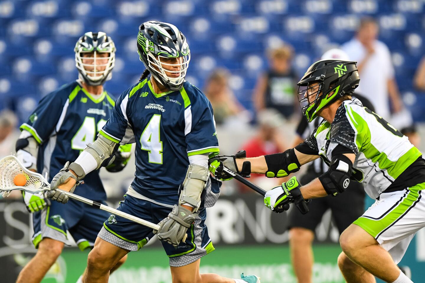 Chesapeake Bayhawks attack Lyle Thompson (4)looks to pass against New York Lizards midfielder Mike Begley (63) during the first quarter at Navy-Marine Corps Memorial Stadium.