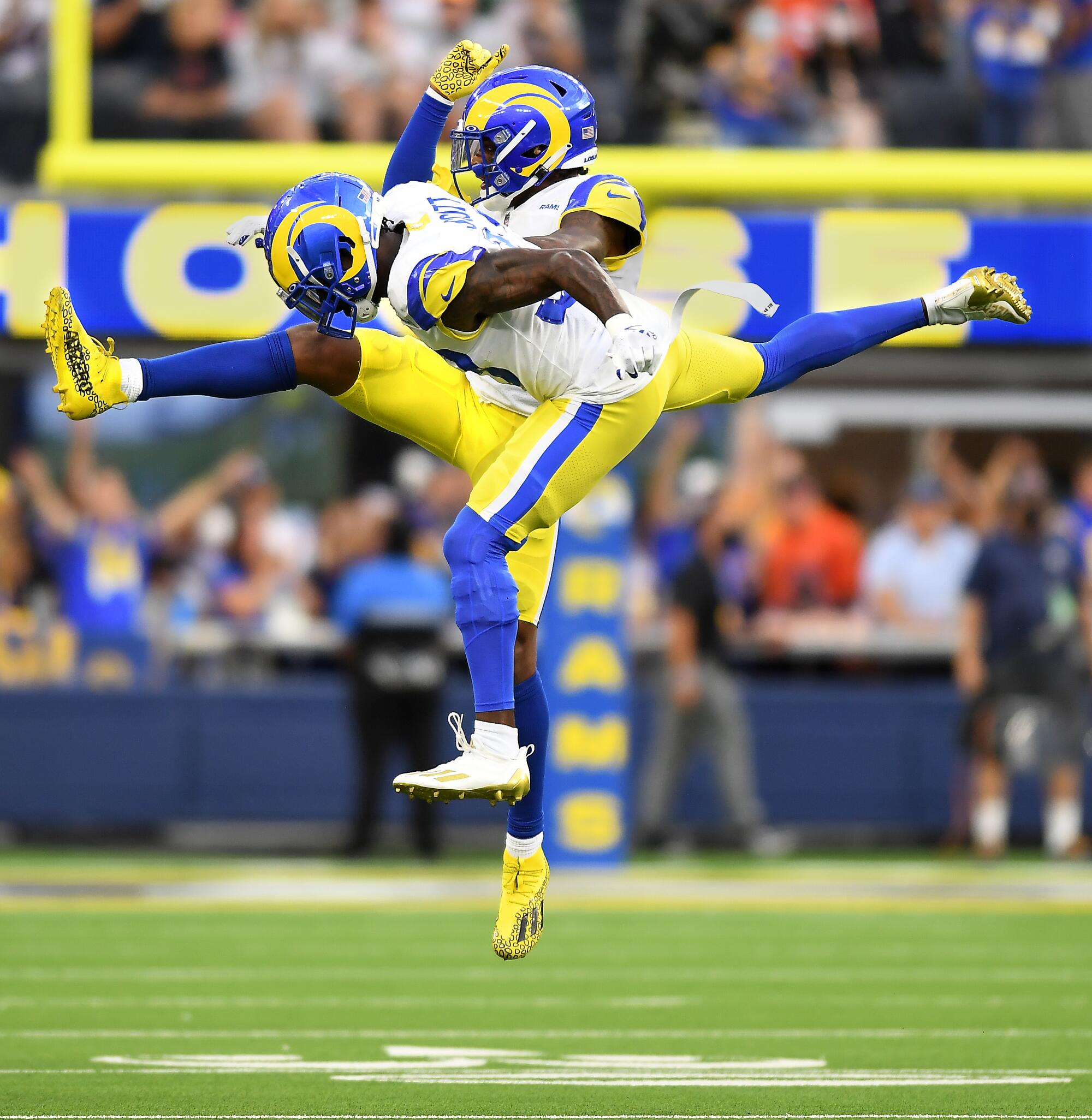 Los Angeles Rams Jalen Ramsey, background, and Nick Scott celebrate after stopping the Chicago Bears on fourth down