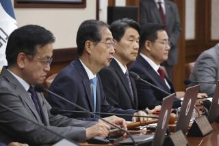 South Korea's Prime Minster Han Duck-soo, second left, speaks during a cabinet meeting at the government complex in Seoul, South Korea, Tuesday, June 4, 2024. South Korea’s government has approved the suspension of a contentious military agreement with North Korea, a step that would allow it to take tougher responses to North Korean provocations.(Choi Jae-gu/Yonhap via AP)