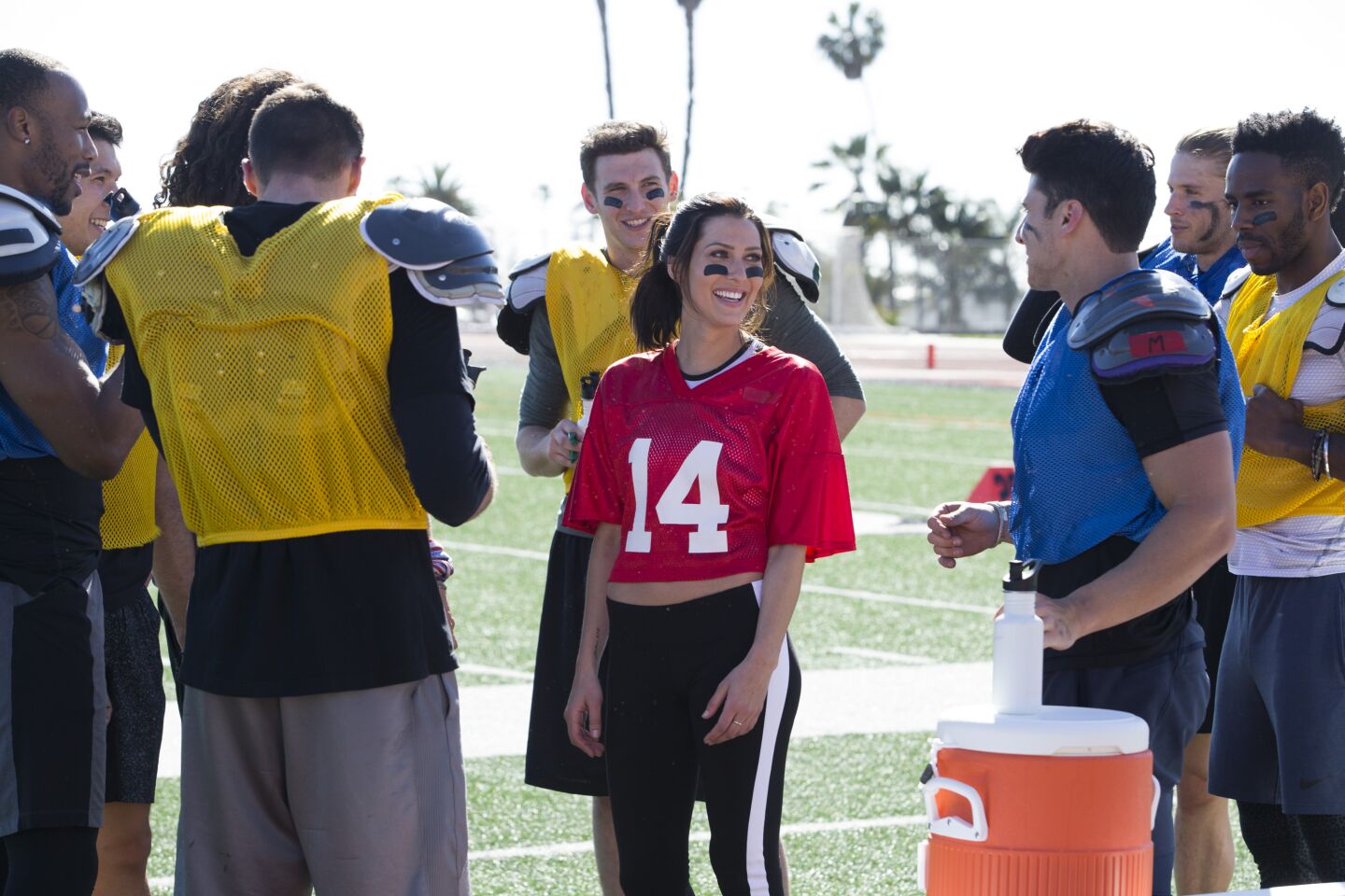Becca Kufrin and her suitors on The Bachelorette compete in a football-themed challenge.