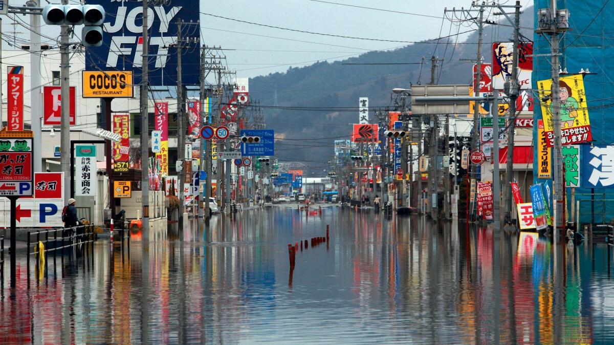 The waters of the tsunami were still evident in the Japanese town of Ishinomaki days after the March 11, 2011 tsunami. (Brian van der Brug / Los Angeles Times)