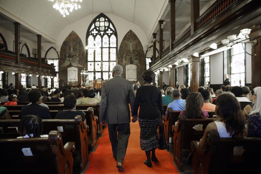 Worshipers enter Emanuel A.M.E. Church in Charleston, S.C., four days after a mass shooting that claimed the lives of its pastor and eight others.