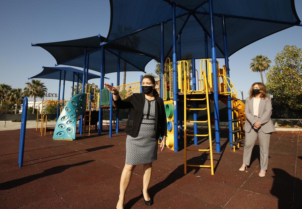 L.A. County schools Supt. Debra Duardo, right, and a Glendale principal, Perla Chavez-Fritz, wear masks at a campus.