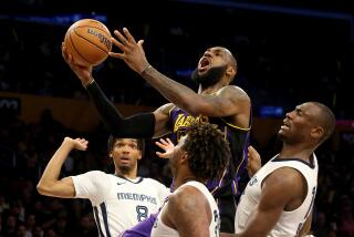 Los Angeles, CA - Lakers forward Lebron James drives to the basket against a trio of Grizzlies defenders.