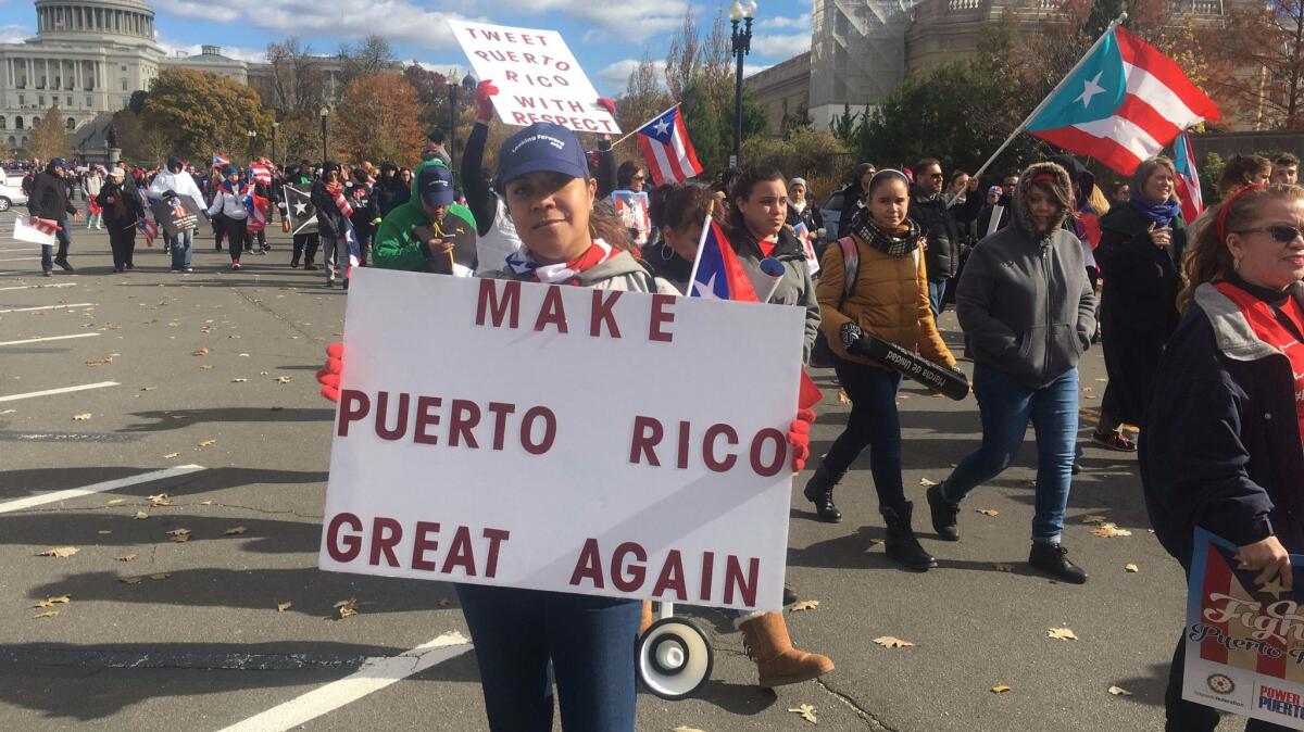 People carry signs during a Nov. 19 Washington protest in support of hurricane-hit Puerto Rico.