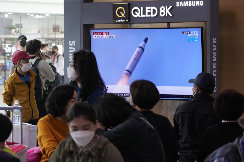 People watch a TV showing a file image of North Korea's missile launch during a news program at the Seoul Railway Station in Seoul, South Korea, Saturday, May 7, 2022. North Korea fired a suspected ballistic missile designed to be launched from a submarine on Saturday, South Korea's military said, apparently continuing a provocative streak in weapons demonstrations that may culminate with a nuclear test in the coming weeks or months. (AP Photo/Ahn Young-joon)