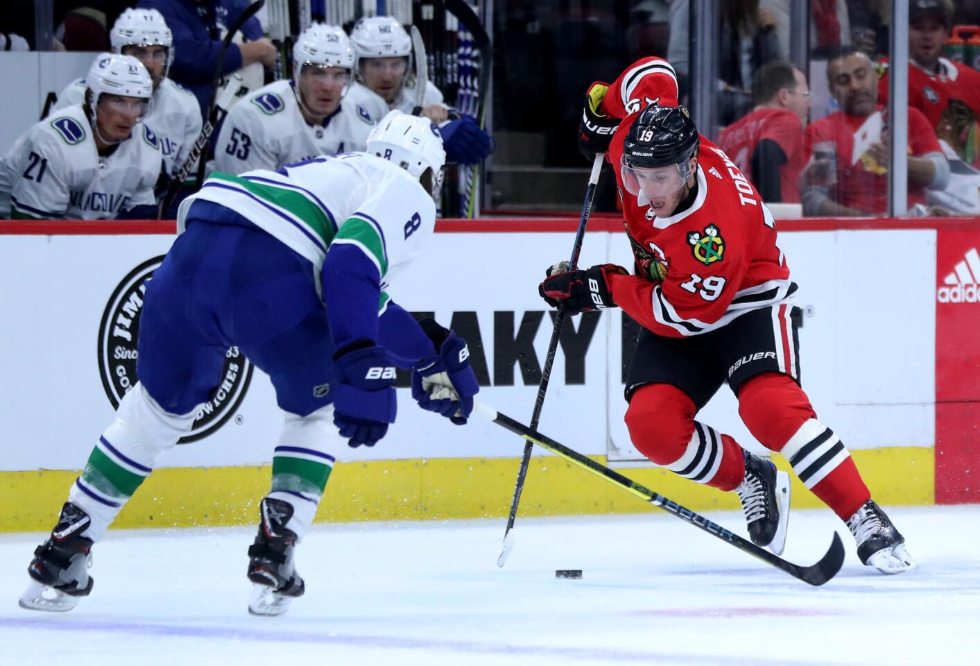 Blackhawks center Jonathan Toews (19) makes a move on Canucks defenseman Christopher Tanev (8) in the first period at the United Center on Thursday, February 7, 2019.