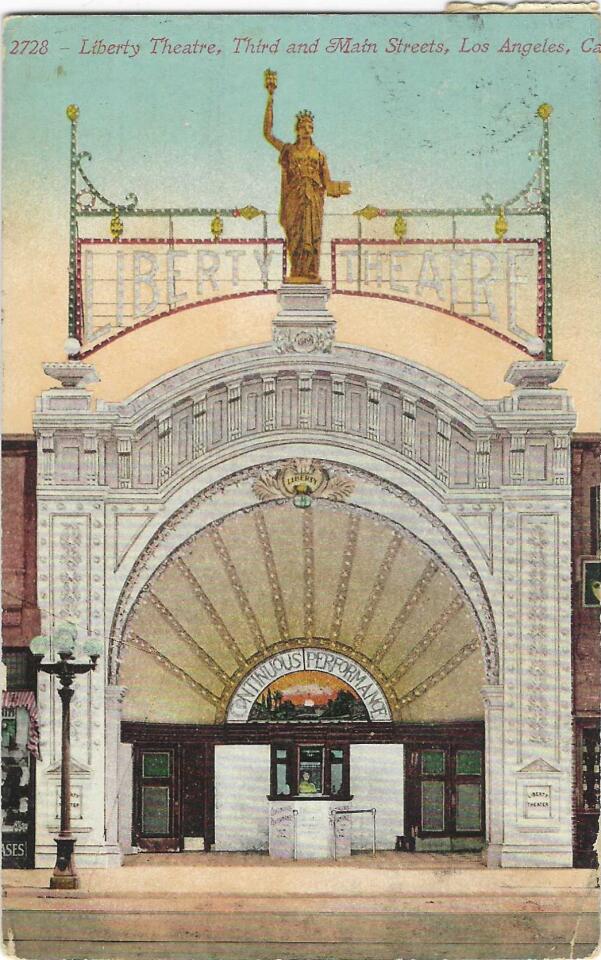 Vintage postcard shows the facade of the Liberty Theatre, with a golden Lady Liberty on the roof.