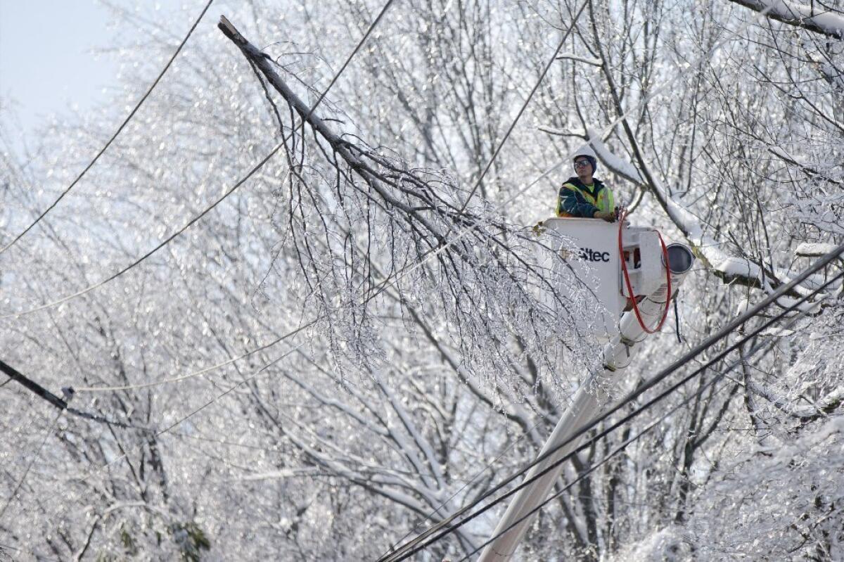 A utility worker tries to restore power in Downingtown, Pa. As of Sunday, at least 50,000 Pennsylvania power customers remained without electricity after a Wednesday morning storm.