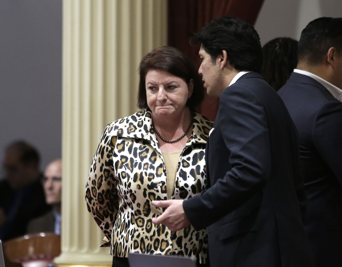Assembly Speaker Toni Atkins talks with Senate President Pro Tem Kevin de León, who is standing firmly behind Sen. Marty Block in what could be a long and expensive fight