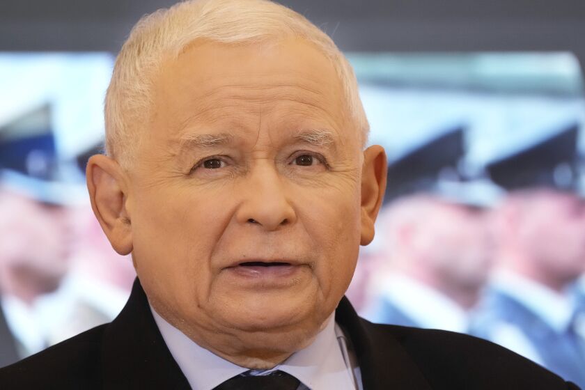 FILE - Poland's deputy prime minister and head of the ruling party, Jaroslaw Kaczynski speaks during a news conference with Defense Minister Mariusz Blaszczak in Warsaw, Poland, on Tuesday, Feb. 22, 2022. The Polish ruling party leader Kaczynski, has paid 50,000 zlotys ($11,500) to the Ukrainian army to settle a defamation case with Radek Sikorski, a member of the European Parliament who is a political rival in Poland. (AP Photo/Czarek Sokolowski, File)