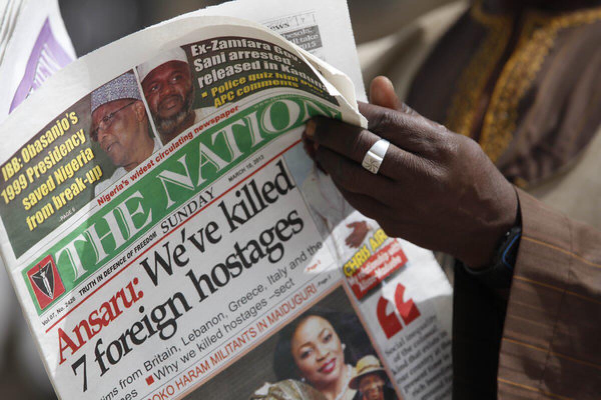 A man in Kano, Nigeria, reads a local newspaper report on the fate of kidnapped construction workers.