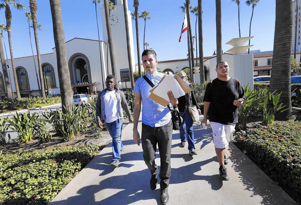 Clients of youth housing and service agency Jovenes walk through Union Station seeking people 24 and younger to count in L.A.'s official homeless tally.