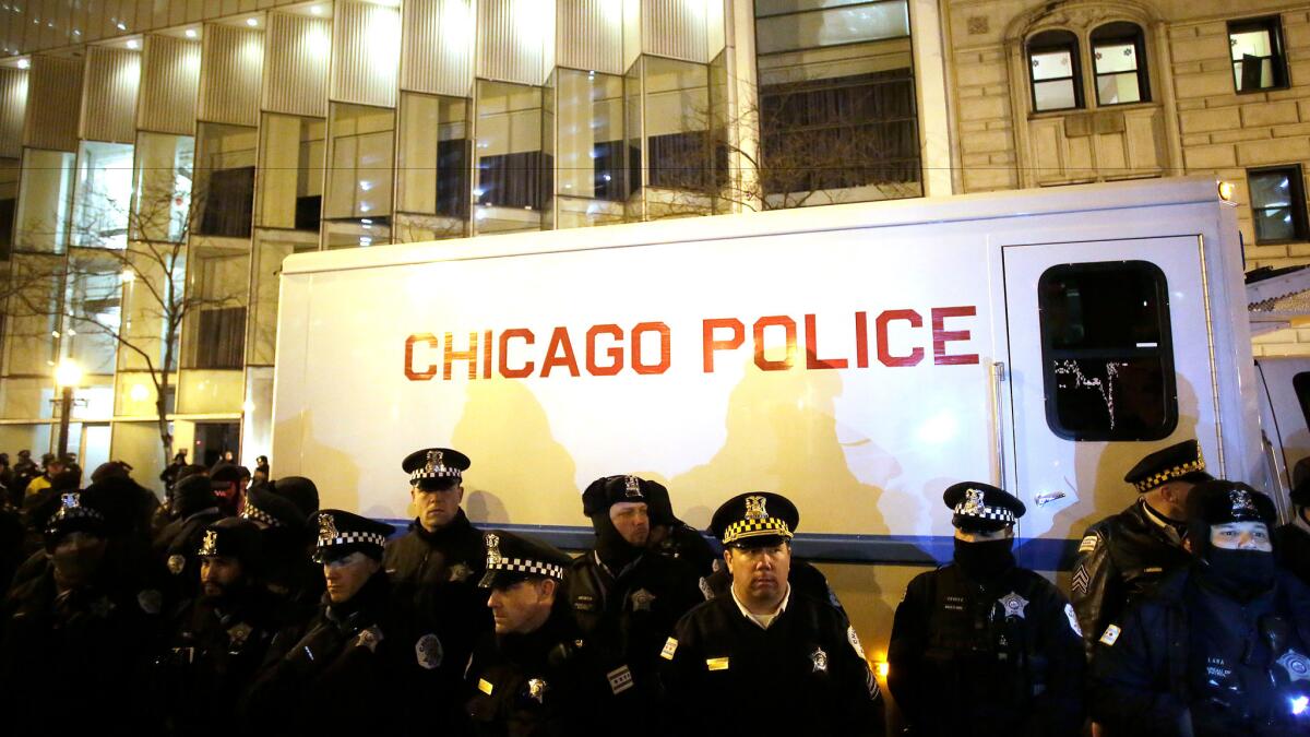 Chicago police stand watch in December 2015 as demonstrators protest the death of Laquan McDonald, who was fatally shot by a police officer.