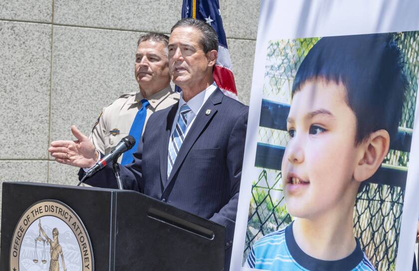 Orange County District Attorney Todd Spitzer announces Tuesday, June 8, 2021, in Santa Ana, Calif., charges filed against suspects Marcus Anthony Eriz and Wynne Lee in the death of Aiden Leos, right, the 6-year-old boy who was shot and killed on his way to kindergarten in his mother's car on the 55 Freeway in Orange on May 21. (Mark Rightmire/The Orange County Register via AP)